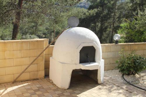 a pizza oven sitting next to a brick wall at House of Roses in Limassol