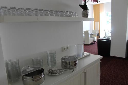 a kitchen with pots and pans on a counter at Wiking Hotel in Henstedt-Ulzburg