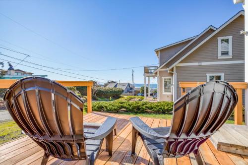 two chairs and a table on a wooden deck at Siren Song in Lincoln City