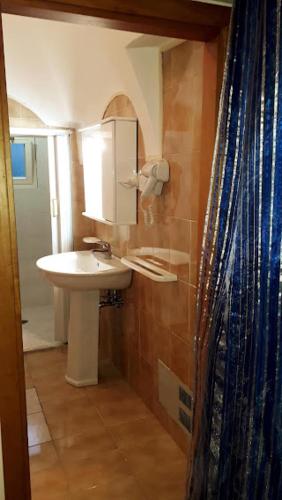 a bathroom with a sink and a shower curtain at In Vacanza a Gaeta - Libera Stella in Gaeta
