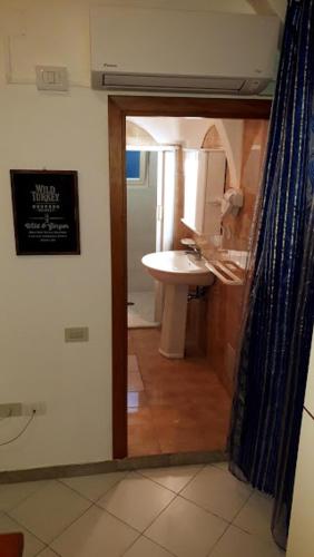 a bathroom with a sink and a shower curtain at In Vacanza a Gaeta - Libera Stella in Gaeta