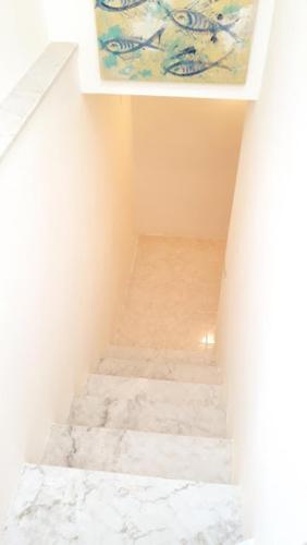a stairway with a painting on top of a wall at In Vacanza a Gaeta - Libera Stella in Gaeta
