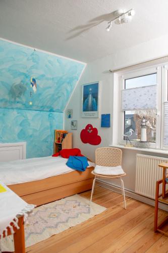 a bedroom with a bed and a large painting on the wall at Haus Haeger in Dahme