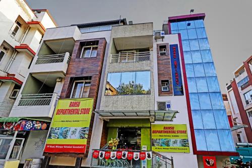 a tall building with glass windows on a city street at Itsy By Treebo - Ransu Residency in Guwahati