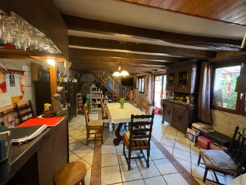 a kitchen with a table and chairs in a room at Chambres, Table d'Hôtes et Gites Les Mesanges in Saint-Jean-de-Sauves