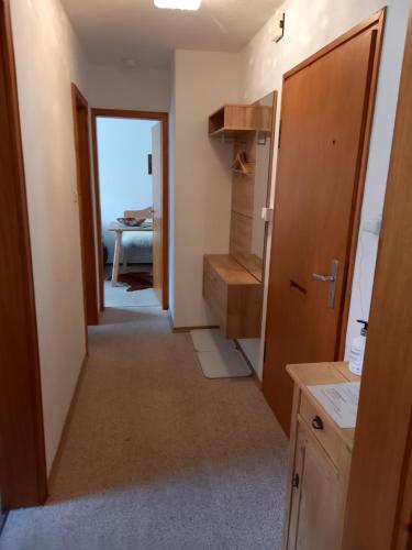 a hallway leading to a room with a kitchen at Ferienwohnung Bayrischzell in Bayrischzell