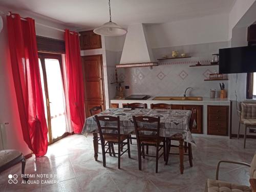 a kitchen with a table and chairs in a room at Casa Chiarenza in Castellammare del Golfo