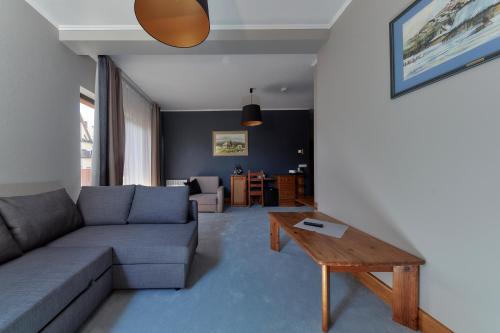 a living room with a couch and a table at Hotel Skalny in Zakopane
