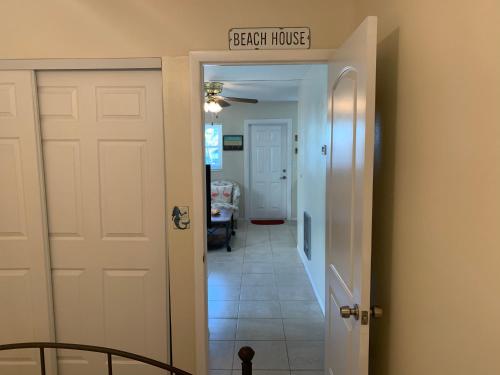 a hallway with a stair house sign above a door at Michaels -Beachside Bungalows in St Pete Beach