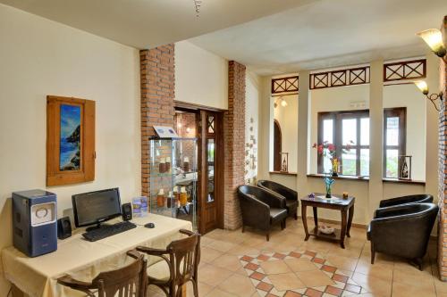a living room with a desk with a computer on it at Katia Hotel in Afissos