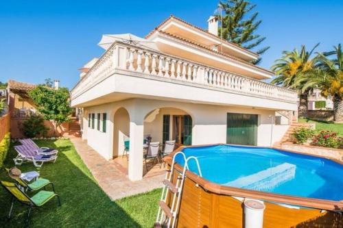 a house with a swimming pool in the yard at *****Villa de Món max. 8 Personen, Meerblick + Pool in Cala Anguila