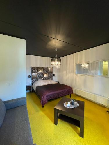 a bedroom with a bed and a coffee table at Guest House Bermuuda Apartment in Paide
