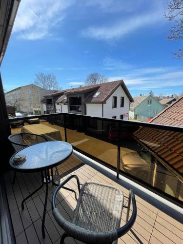 a balcony with a table and chairs on a roof at Guest House Bermuuda Apartment in Paide