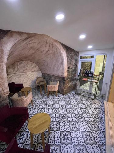 a room with a stone wall with a table and chairs at Hotel Novano in Istanbul