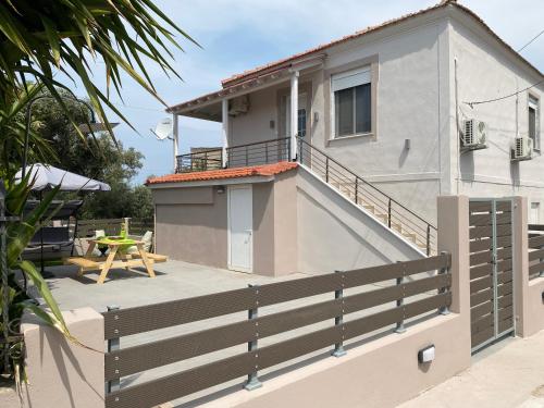 a balcony of a house with a table and a patio at Casa Mariei in Skala Kallirakhis