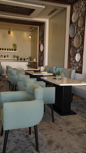 a row of tables and chairs in a room at Clowzer Hotel in Riyadh