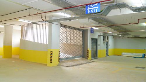 an empty parking lot with a gate in a parking garage at Clowzer Hotel in Riyadh