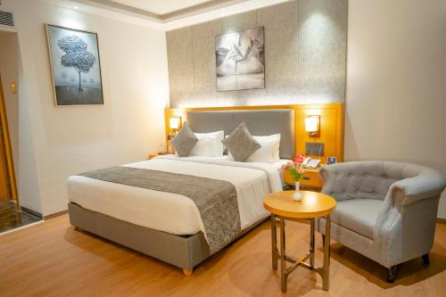 a hotel room with a bed and a chair at Zip By Spree Hotels Chakan, Pune in Pune