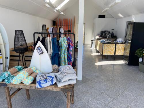 a store with a rack of clothes in a room at Viking Surf House in Klitmøller