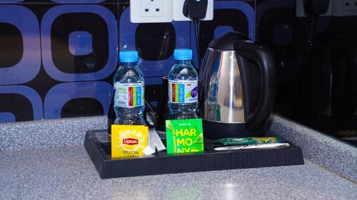 a counter with two bottles of water and a coffee pot at Clowzer Hotel in Riyadh