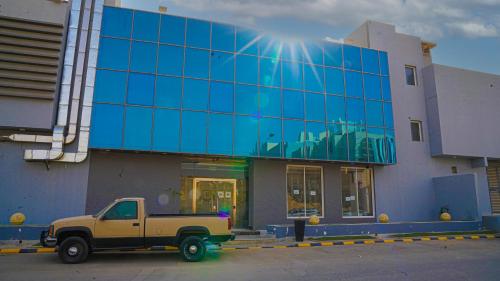 a truck parked in front of a building at Clowzer Hotel in Riyadh