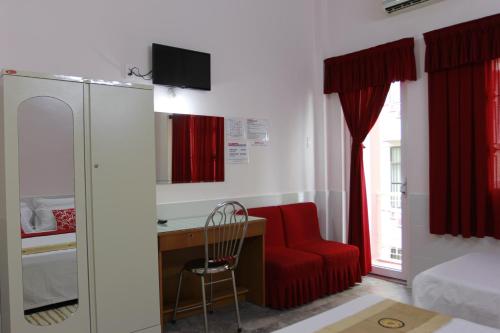 a room with a red chair and a desk and a bed at QUANG SAIGON Hotel- 40-7 Bùi Viện-Walking street in Ho Chi Minh City