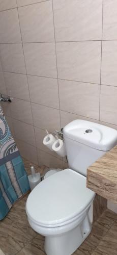 a bathroom with a white toilet and a sink at Ilio Socrates in Skala Marion