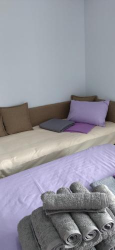 a bed with two towels on top of it at Ilio Socrates in Skala Marion