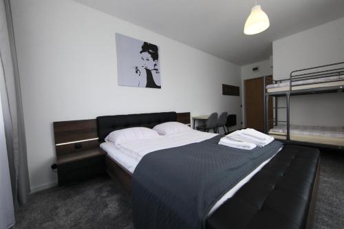 a bedroom with a large bed with a black headboard at Willa Park Międzyzdroje in Międzyzdroje
