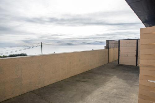 a concrete wall with two white doors on it at GarçaView in Vila Franca do Campo