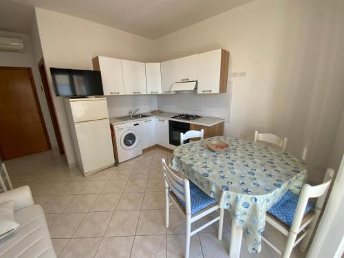 a kitchen with a table and chairs and a kitchen with a stove at Bella Vista apartment in Chioggia