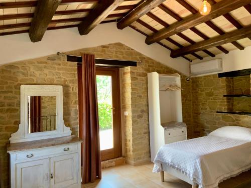 A bed or beds in a room at agriturismo borgo del ginepro