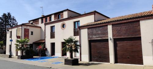 two sets of garage doors on a building at Hotel La Bosselle in Saint-Philbert-de-Grand-Lieu