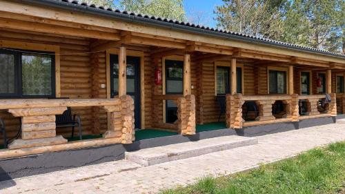 a log cabin with a porch and windows at Siocamping in Siófok