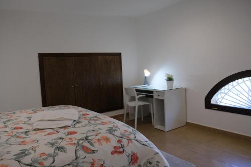 a bedroom with a bed and a desk and a window at Villa Salvius Pompei in Pompei
