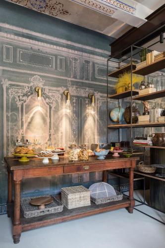 a kitchen with a table with food on it at Antica Dimora Le Misure in Cervia
