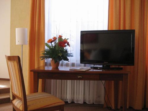 a television sitting on a table in a room at Altstadthotel Schex in Altötting