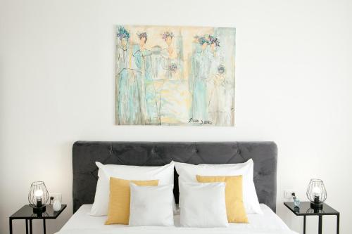 a bedroom with a bed with a painting above it at Apartment Mila in Zadar