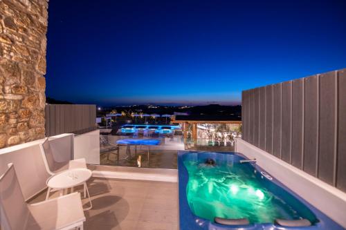 a indoor swimming pool with a water slide at Bianco a Nero Mykonos in Mýkonos City