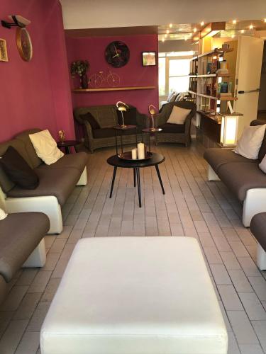 a living room with couches and a table in a room at Hotel del Falco in Cervia