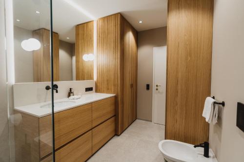 a bathroom with a sink and a mirror at meralino boutique apartment in Merano