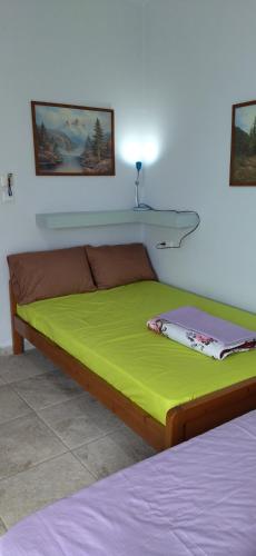 a bedroom with a bed with a green mattress at Ilio Socrates in Skala Marion