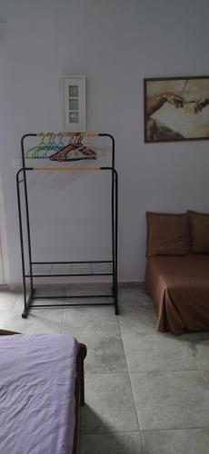 a room with a bed and a table and a couch at Ilio Socrates in Skala Marion