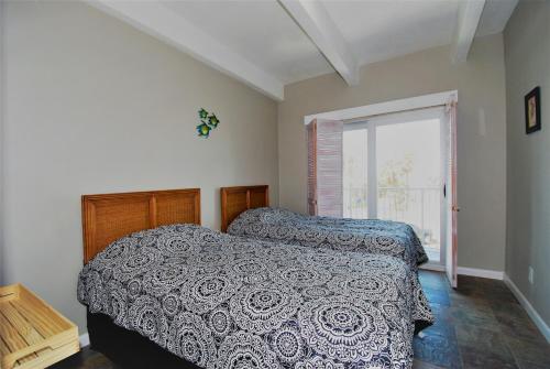 een slaapkamer met een bed en een groot raam bij Aquarius Condo unit 207 condo in South Padre Island