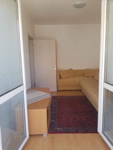 a living room with a couch and a table at Kragić apartman in Soko Banja