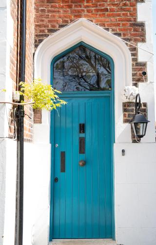 a blue door on a building with a brick wall at The Greenhouse in Portsmouth