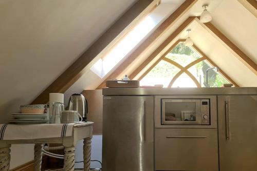 a kitchen with a refrigerator and a window at 2 Westview in St. Brelade