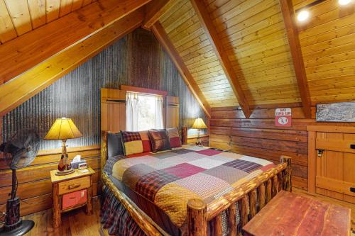 a bedroom with a bed in a wooden cabin at Rocky Mountain Way in Pagosa Springs