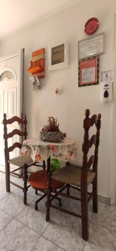a dining room with two chairs and a table at Kostas Apartments in Kourouta