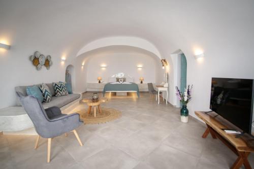 a living room with a couch and a table at Sun Angelos Oia - Luxury Cave Suites in Oia